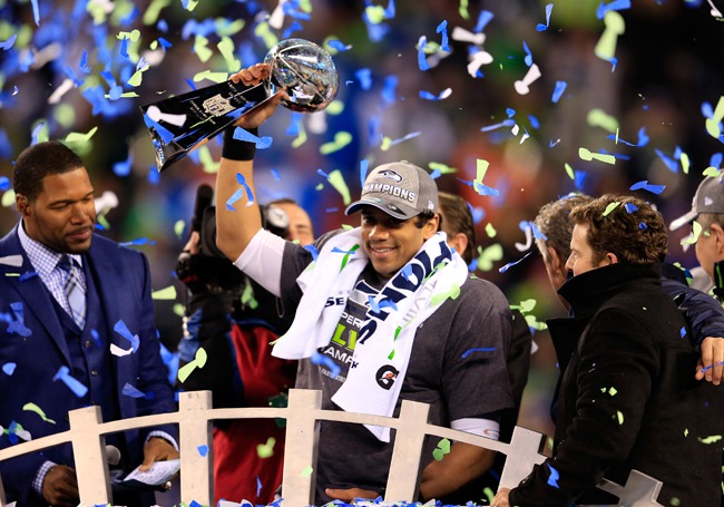 Seattle Seahawks Russell Willson lifts Superbowl Trophy with Confetti